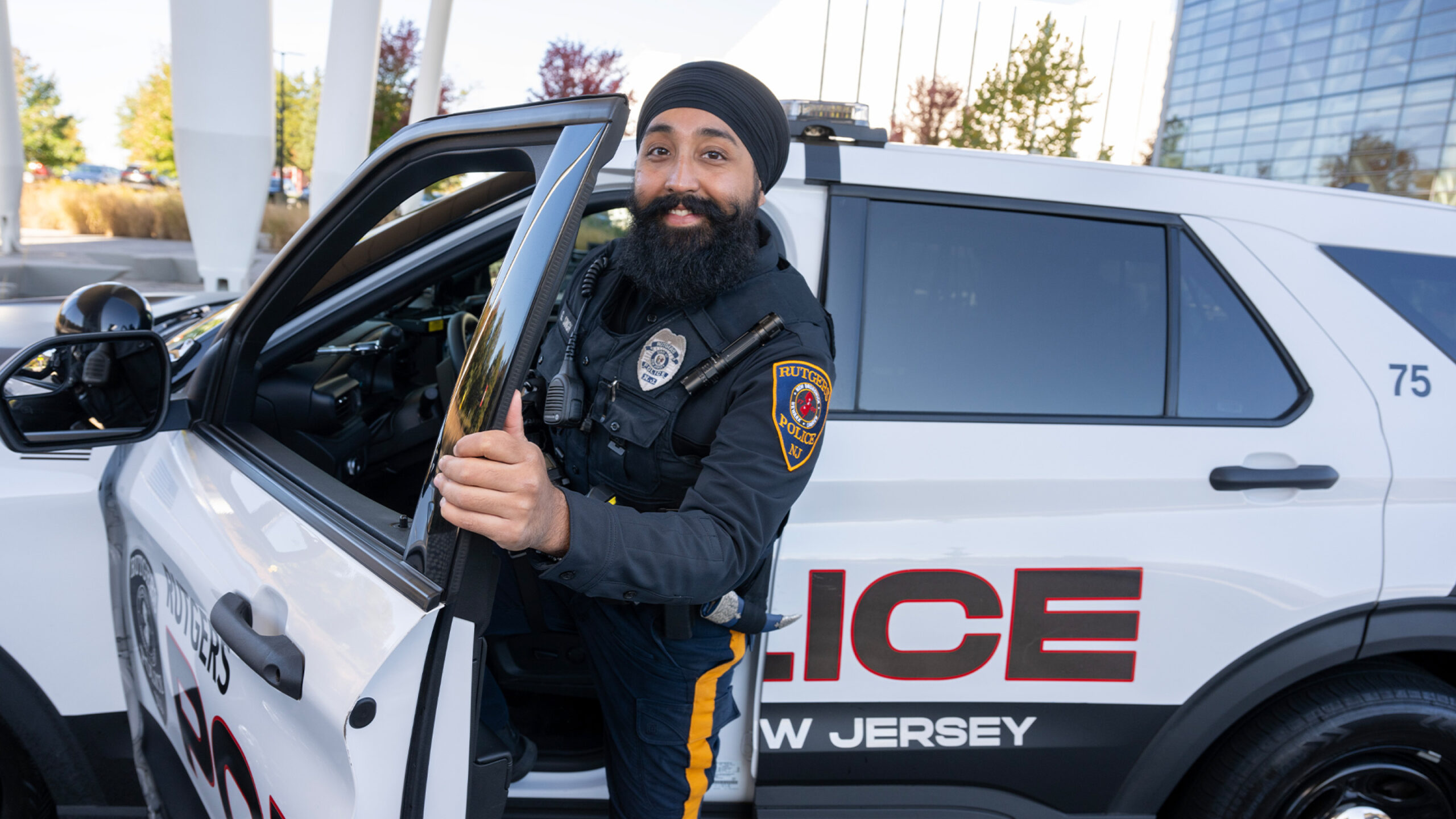 Police officer in front of his car